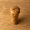 The Alba Olive Wood Pepper Mill seen from above, the full grain readable