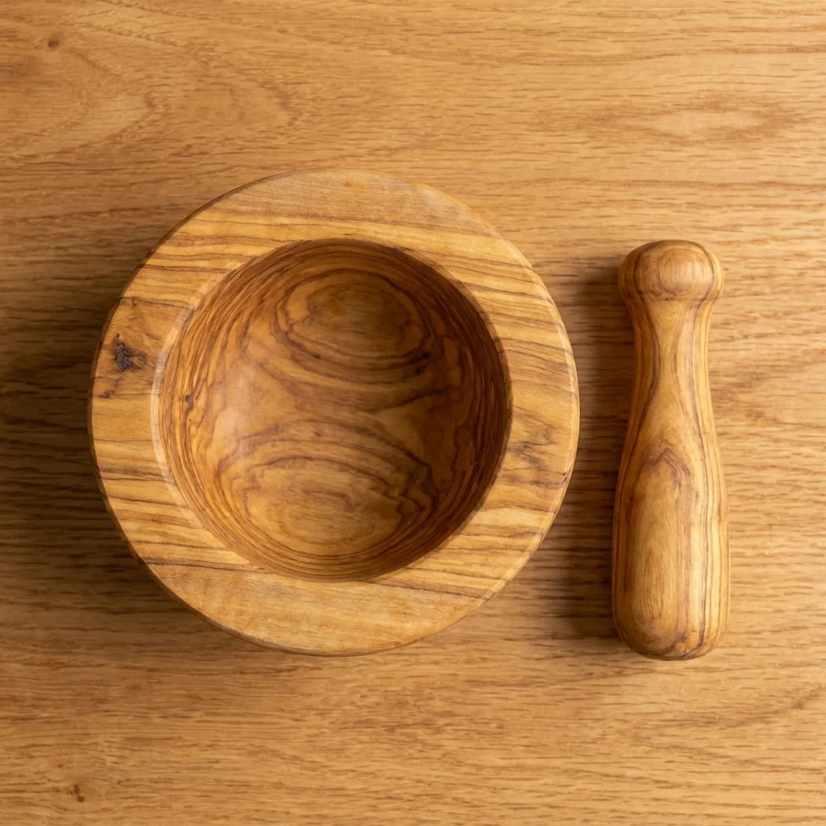The Alba Olive Wood Mortar and Pestle seen from above, the full grain readable