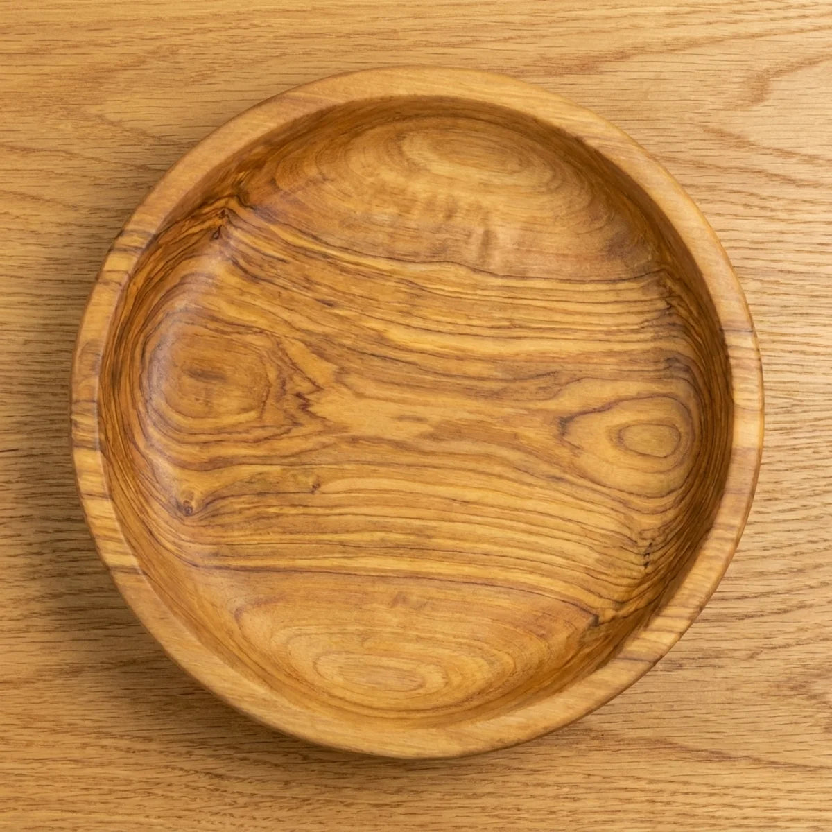 The Alba Olive Wood Bread Bowl seen from above, the full grain readable