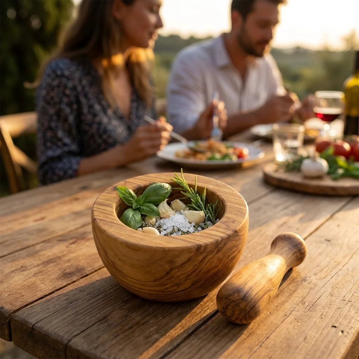 The Alba Olive Wood Mortar and Pestle in use on a dining table
