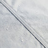 Close-up of the waterproof outer face with water beading on a welded seam
