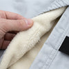 A hand pressing into the cream fleece lining on the inside of the cover