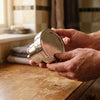 The filtered shower head held in two hands, whole product visible