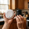 The controller and the coil held in two hands, both entirely visible