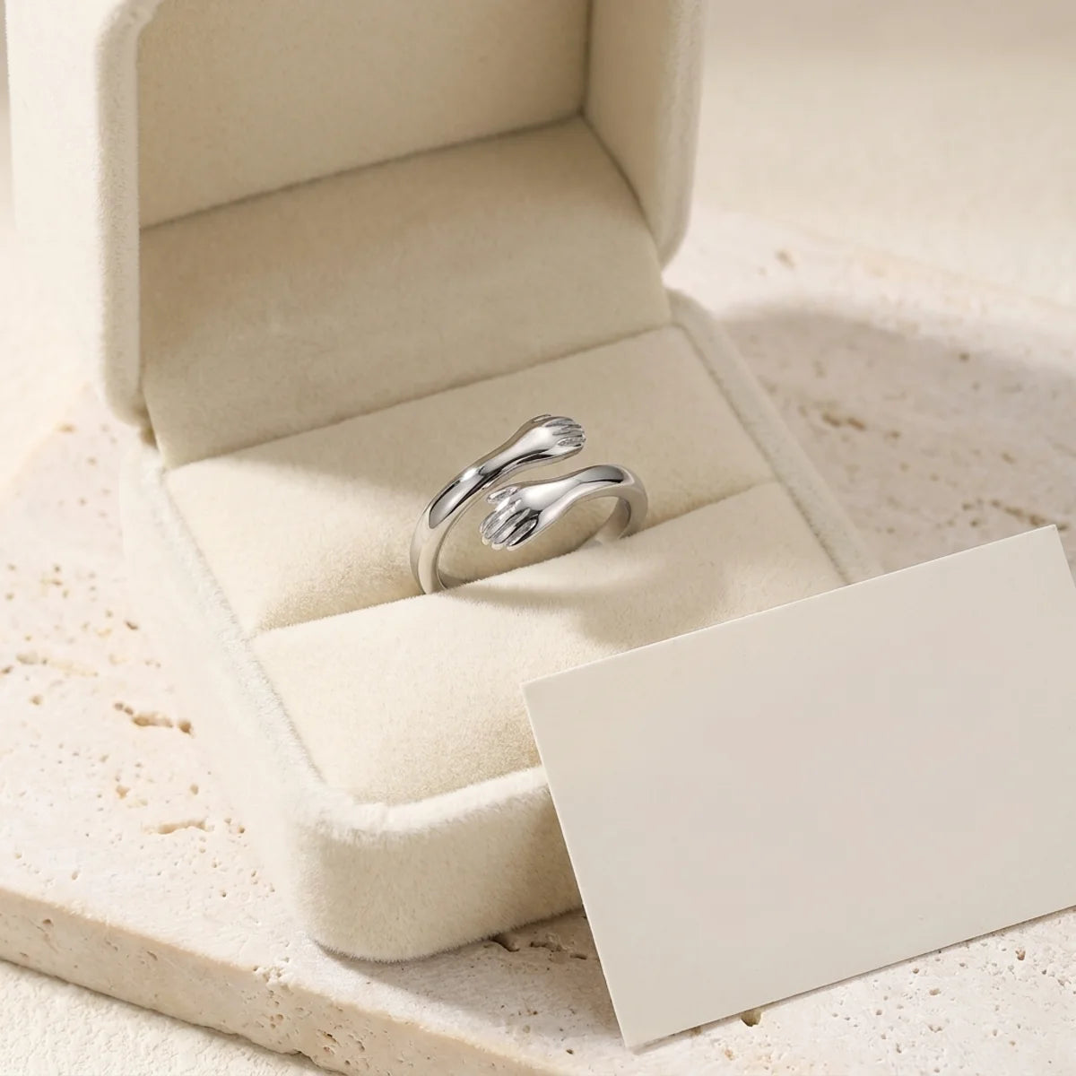 The Hug Ring in its open gift box with a blank message card