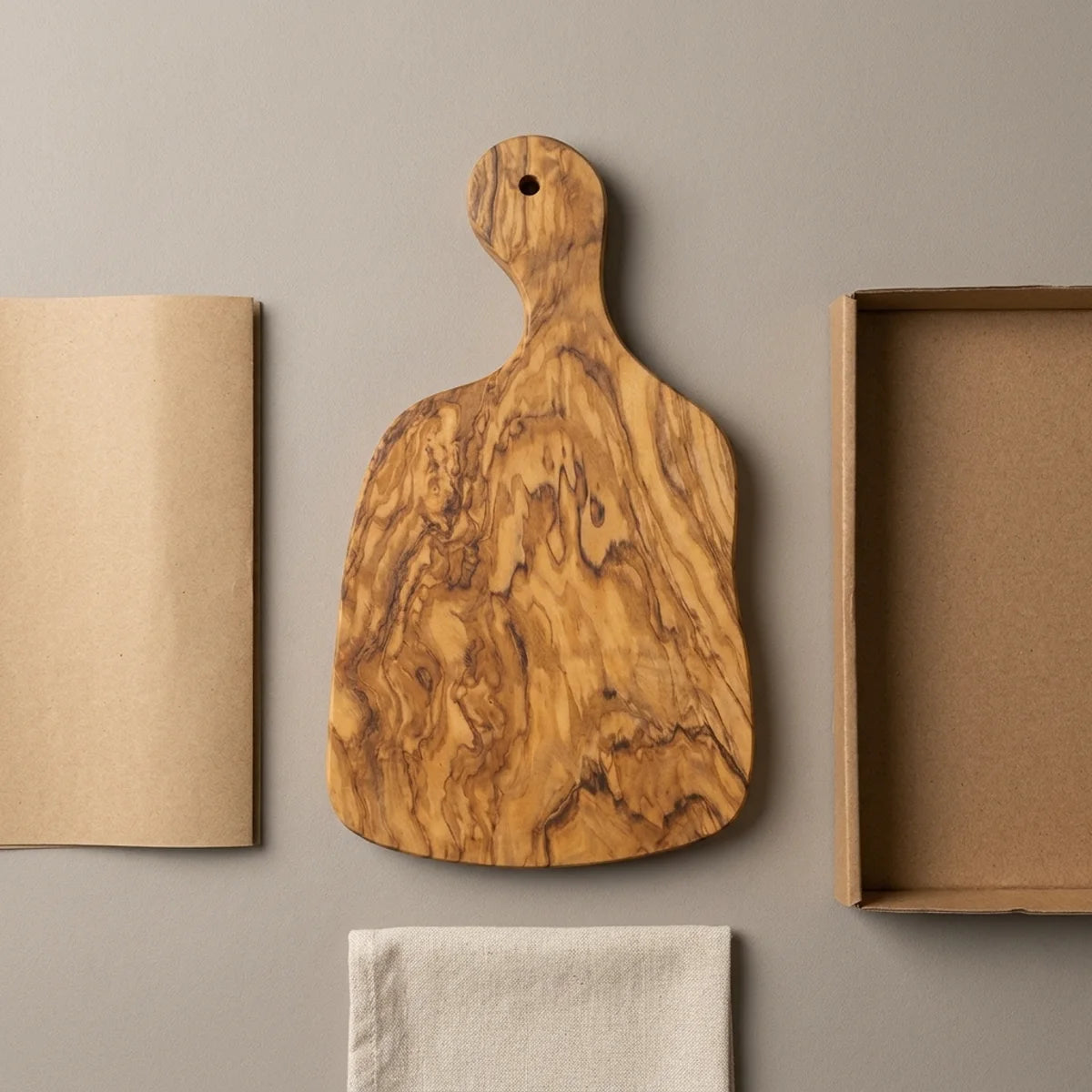 The Alba Olive Wood Paddle Board with its kraft wrapping and plain shipping box
