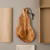 The Alba Olive Wood Board with Leather Loop with its kraft wrapping and plain shipping box