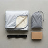 What is in the box: the folded cover, the storage bag and the strap with its buckle
