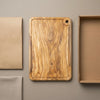The Alba Olive Wood Carving Board with Juice Groove with its kraft wrapping and plain shipping box