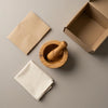 The Alba Olive Wood Mortar and Pestle with its kraft wrapping and plain shipping box