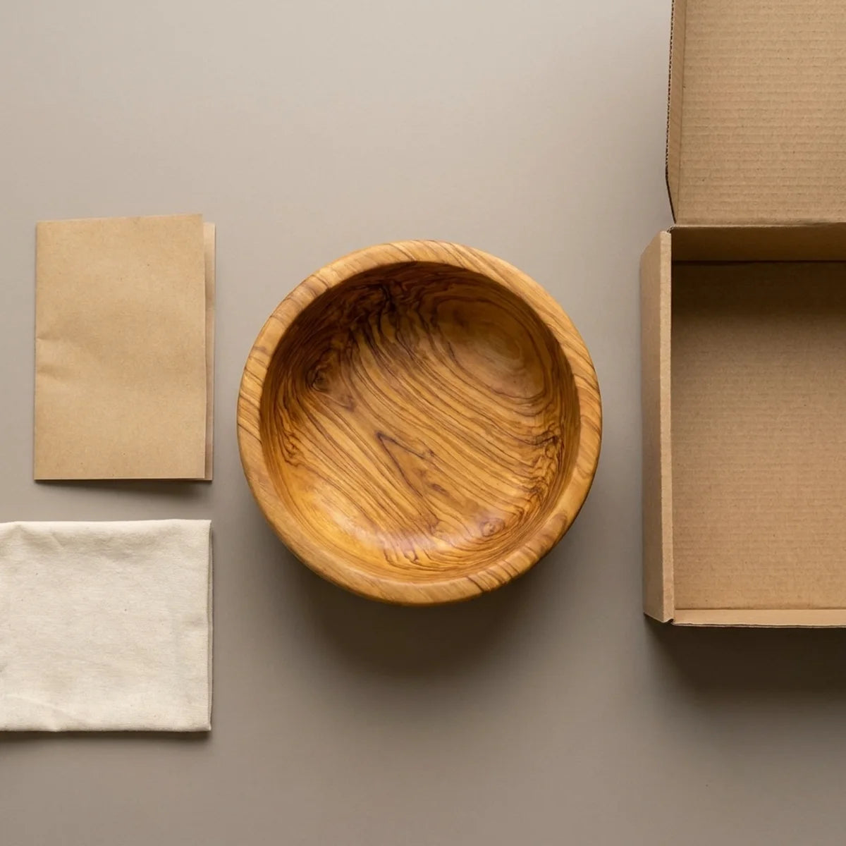 The Alba Olive Wood Salad Bowl with its kraft wrapping and plain shipping box