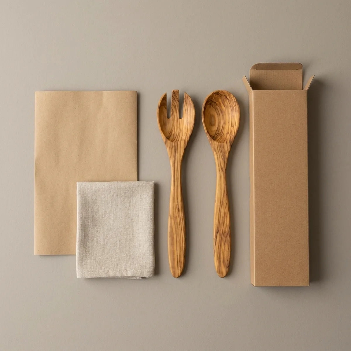 The Alba Olive Wood Serving Set (Fork + Spoon) with its kraft wrapping and plain shipping box