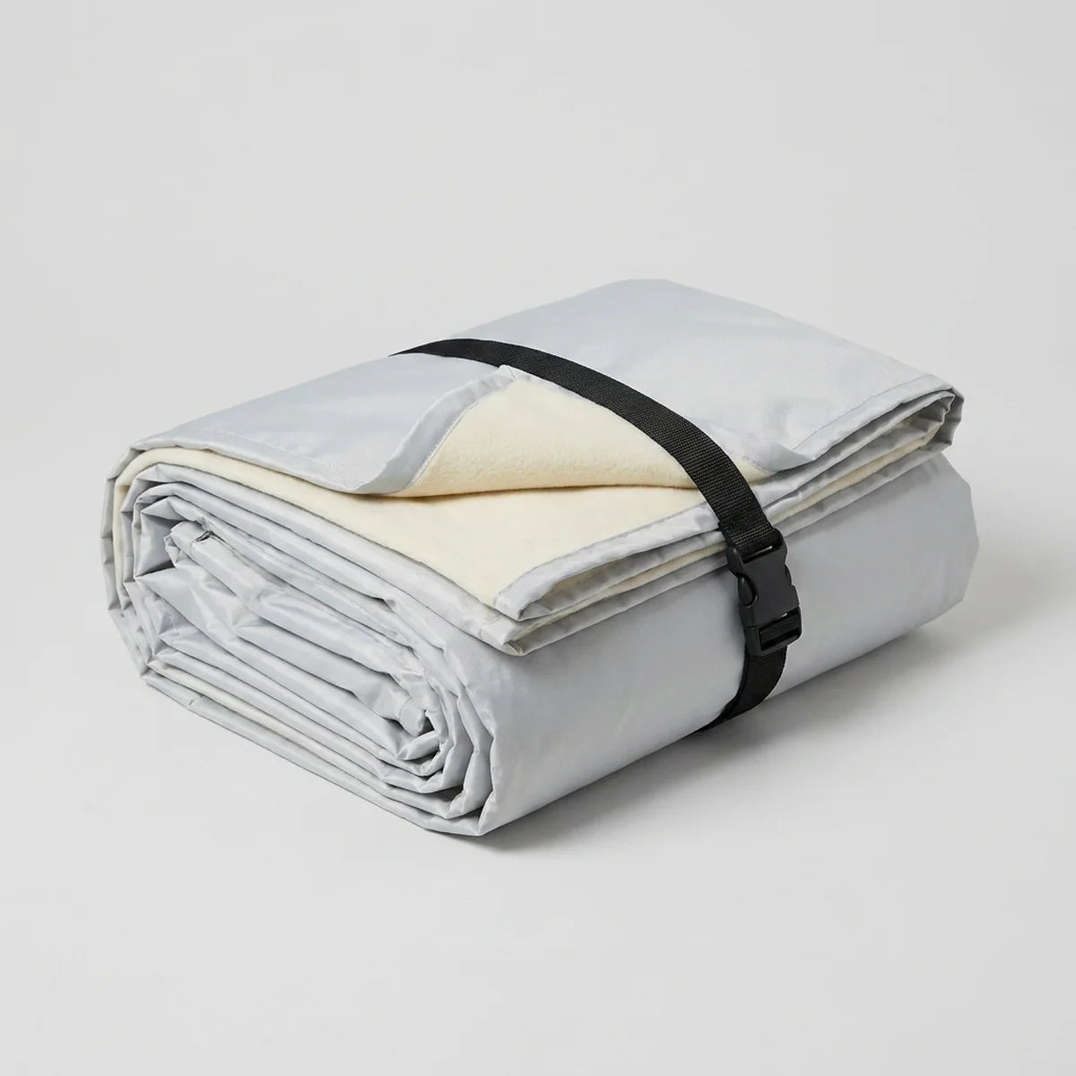 The folded car cover on a plain background