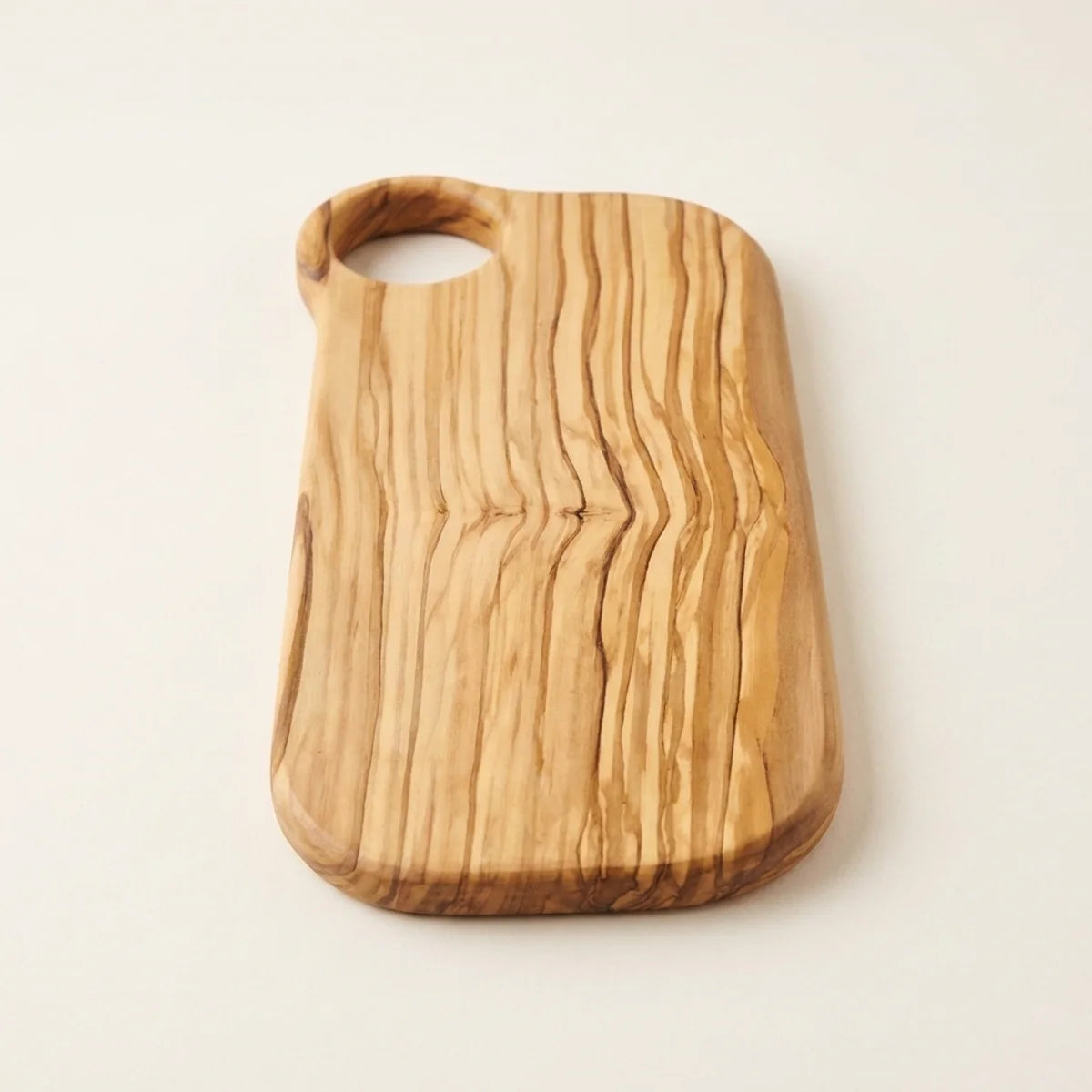 The Alba Olive Wood Board with Grip Hole alone on a plain background