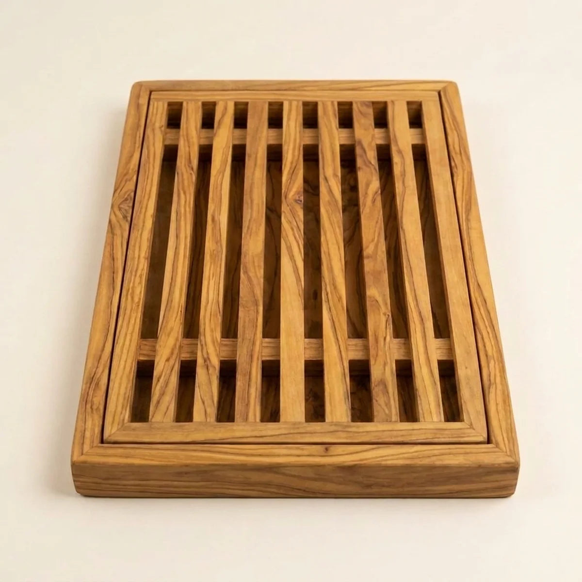The Alba Olive Wood Bread Board with Crumb Tray alone on a plain background
