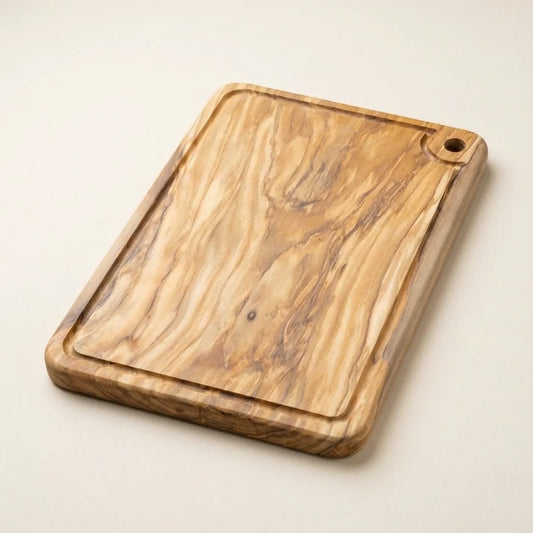 The Alba Olive Wood Carving Board with Juice Groove alone on a plain background